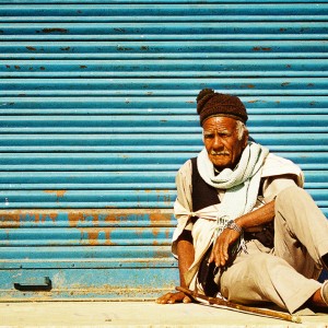 Nepal - Man on front of blue wall